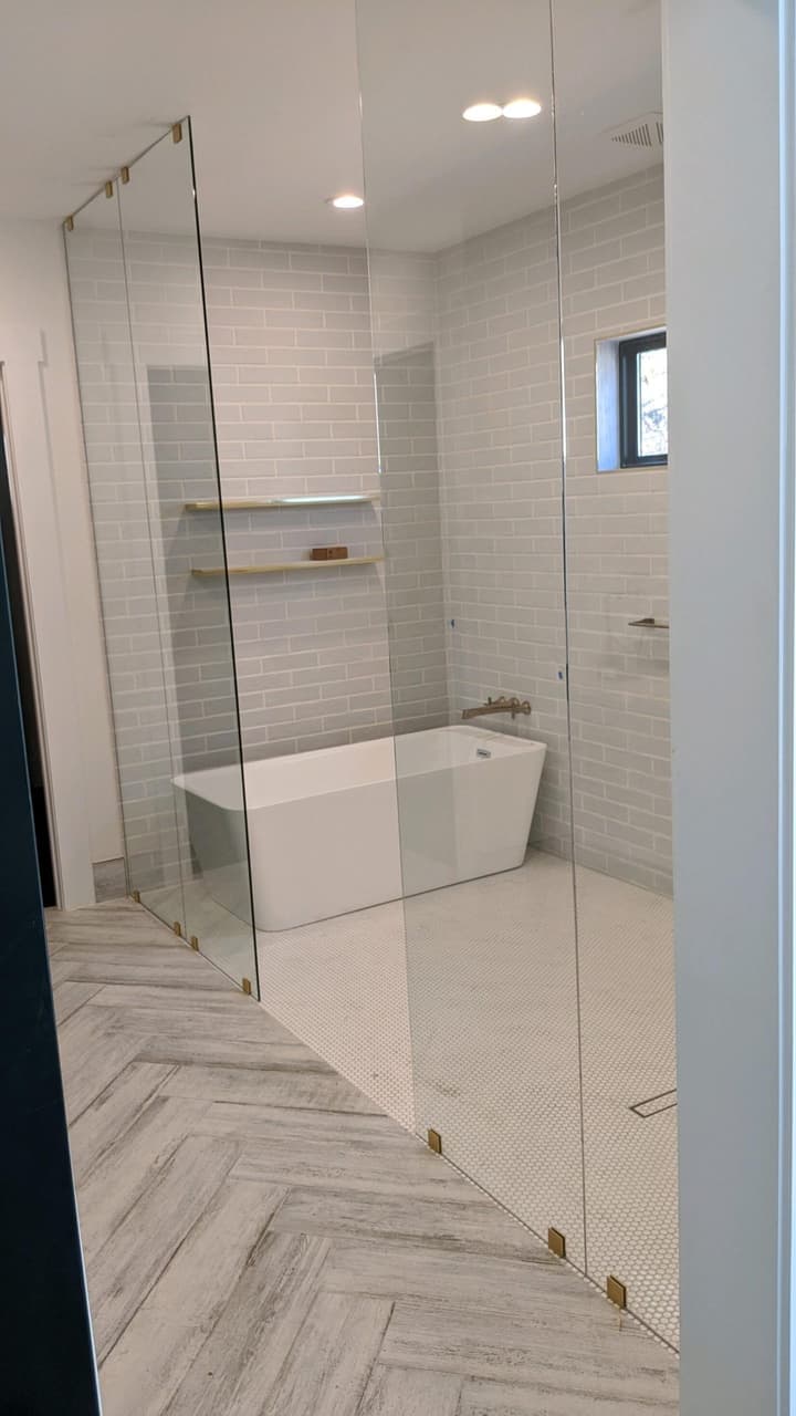 Frameless glass shower door installed by Door Pro Plus in a Texas Hill Country bathroom