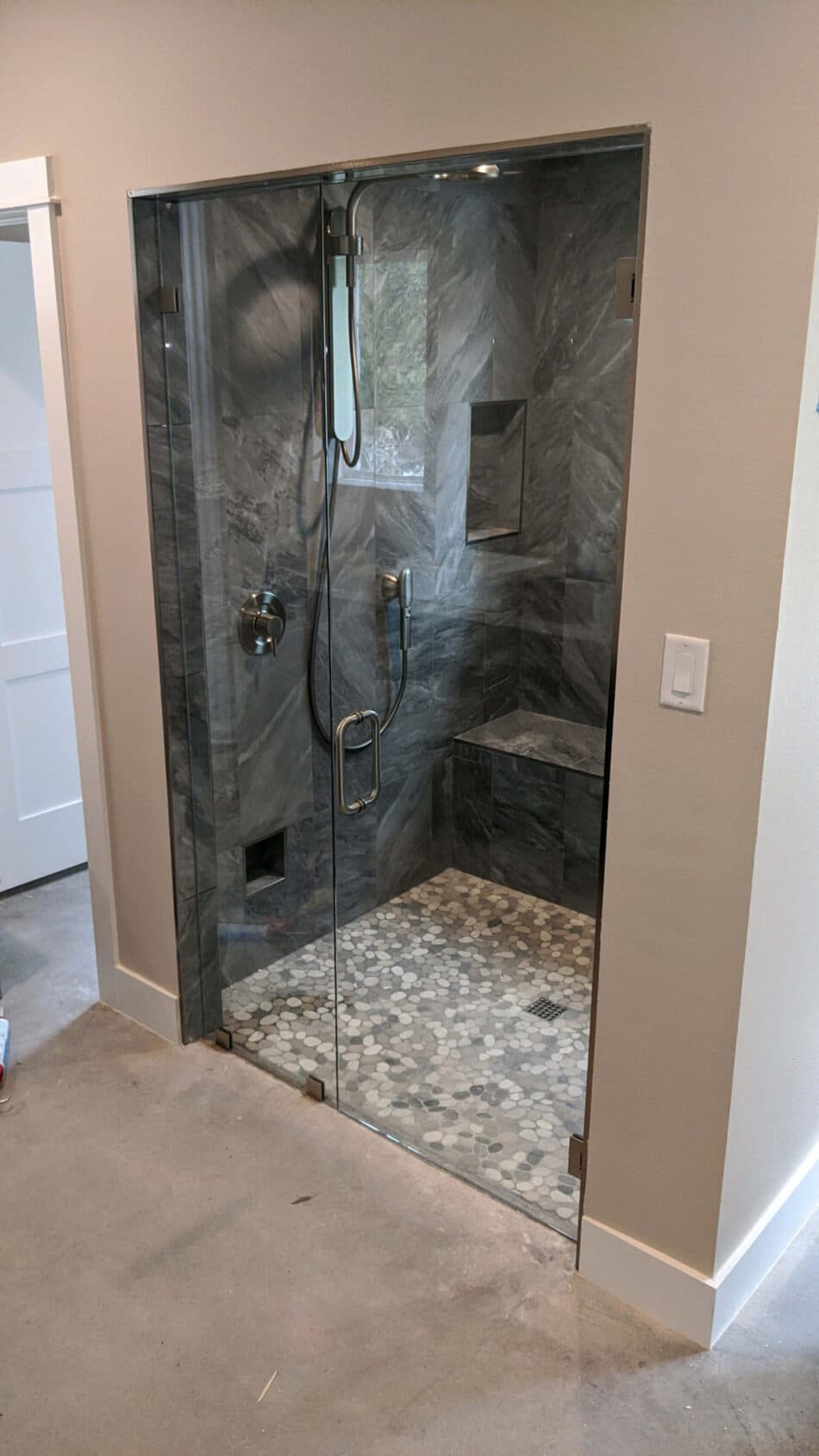 Frameless shower door with premium hardware installed by Door Pro Plus