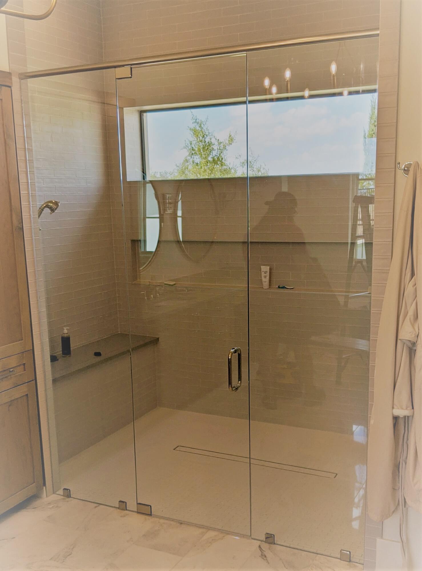 Custom frameless glass shower door installed by Door Pro Plus in a Marble Falls, TX bathroom