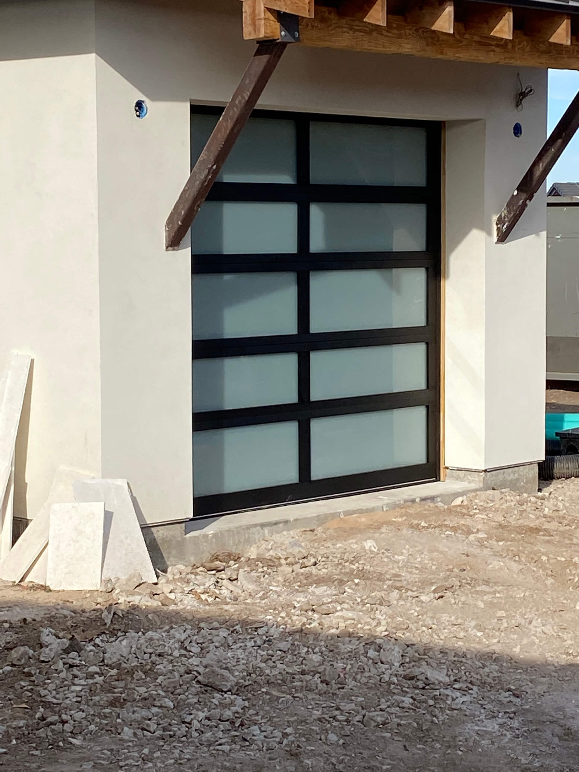 Carriage-style wood garage doors installed by Door Pro Plus on a Texas Hill Country home